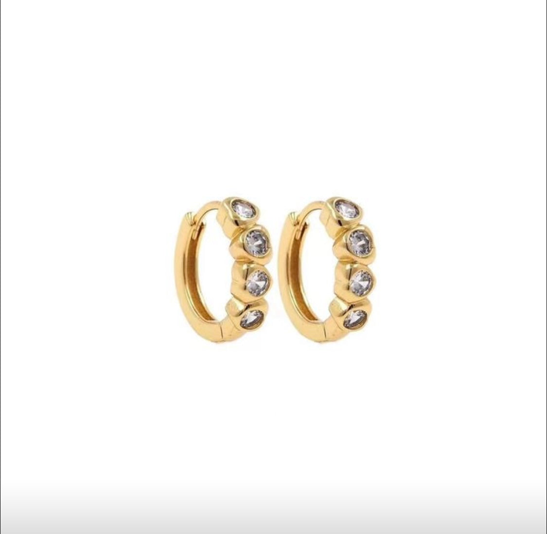 Gold hoop earrings with embedded stones on a white background