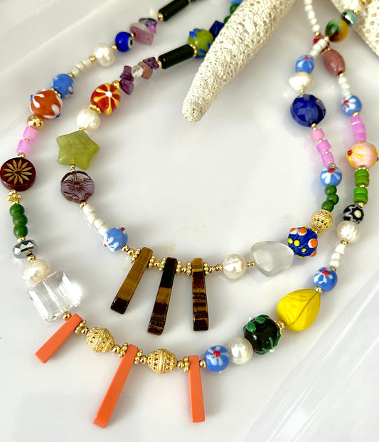 Colorful beaded necklace on a white surface