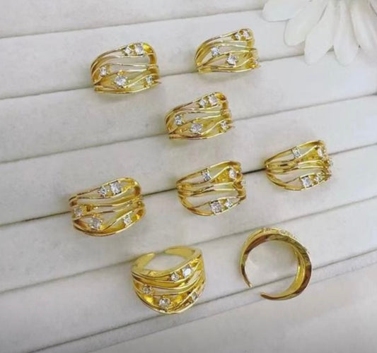 Gold rings with diamond accents on a white surface