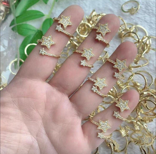 Gold star-shaped jewelry on a hand with a blurred background