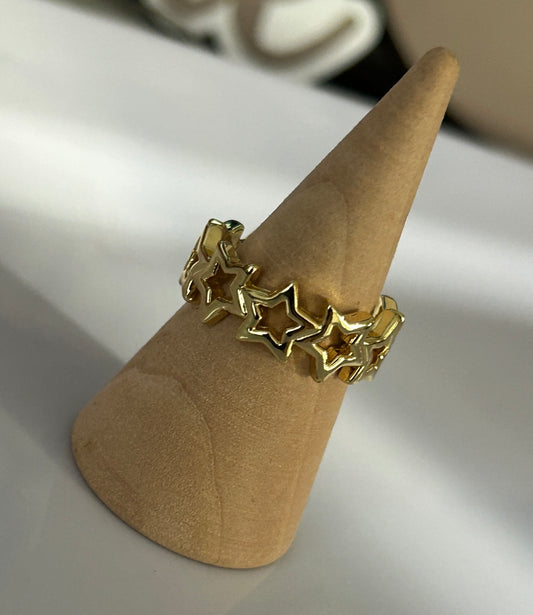 Gold star-shaped ring on a wooden cone