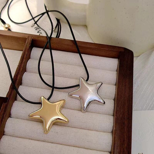 Star-shaped pendants on a wooden stand with a neutral background